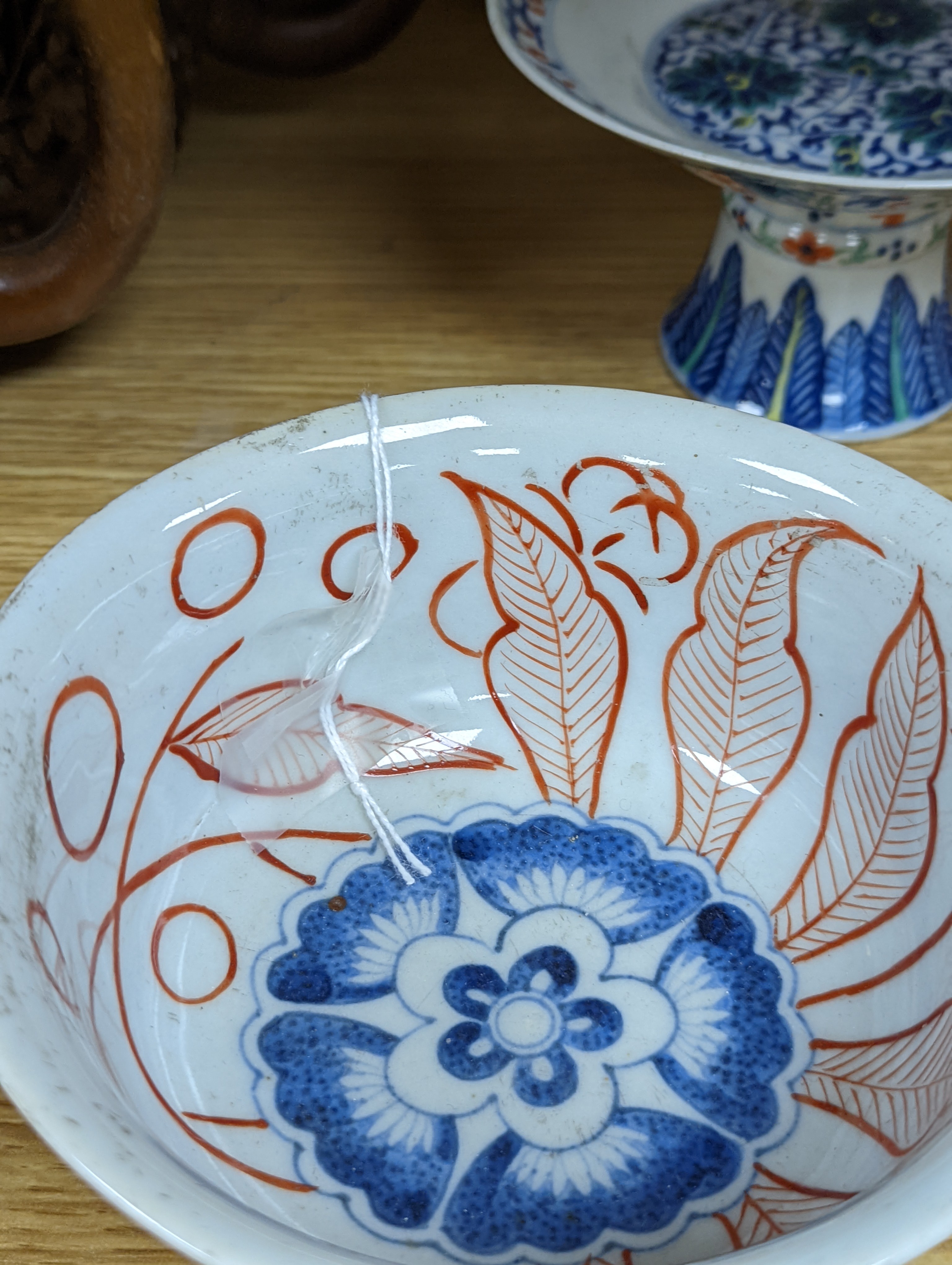 A Chinese blue and white water pipe vessel, a doucai stem dish and a Japanese Imari bowl, 19th century, (3)